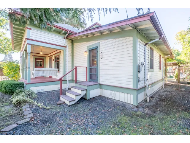 a view of a small house with a yard