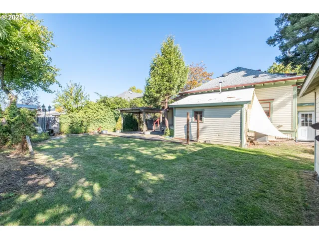 a view of a house with yard and a garden