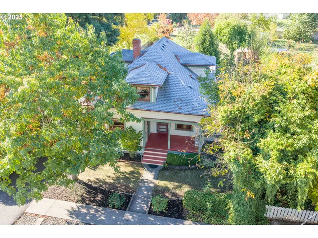 an aerial view of a house with a yard