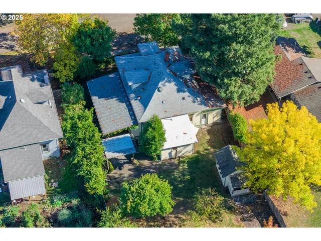 aerial view of a house with a yard and garden