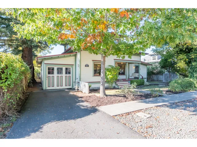 front view of a house with a tree in a yard