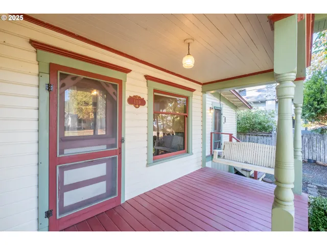a view of an entryway with wooden floor and door