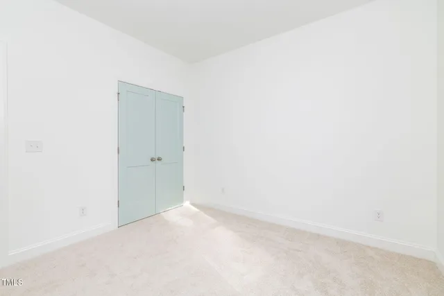 an empty room with windows and entrance