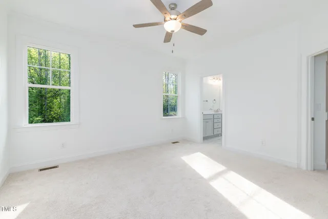 an empty room with a empty space and a ceiling fan