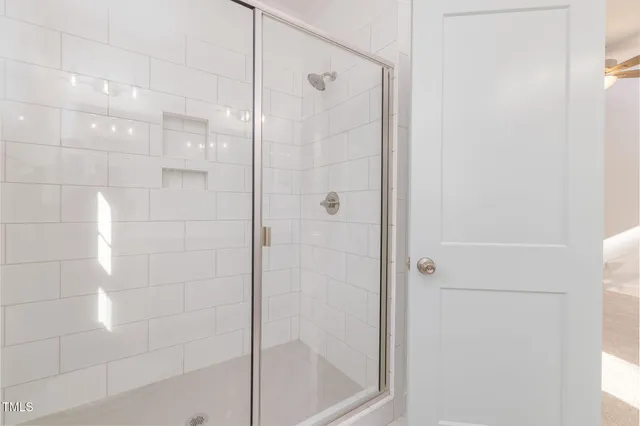 a room with walk in closet with wooden floor