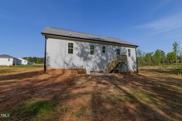an aerial view of a house with outdoor space