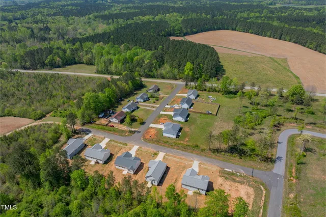 an aerial view of a house with outdoor space