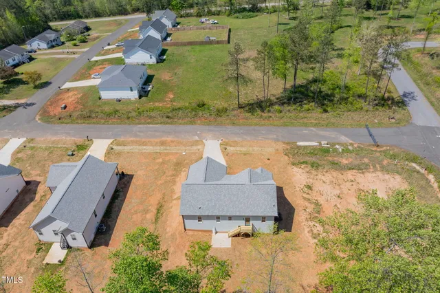 an aerial view of a house with a yard