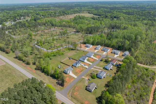 a view of a swimming pool with lawn chairs and couches