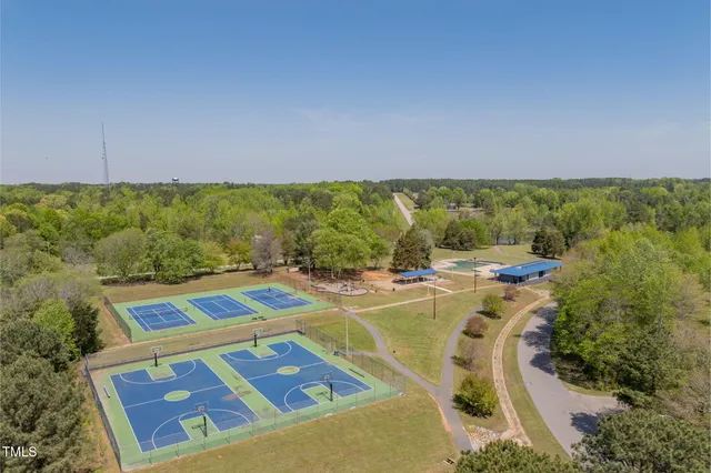 a view of a swimming pool with lawn chairs and couches