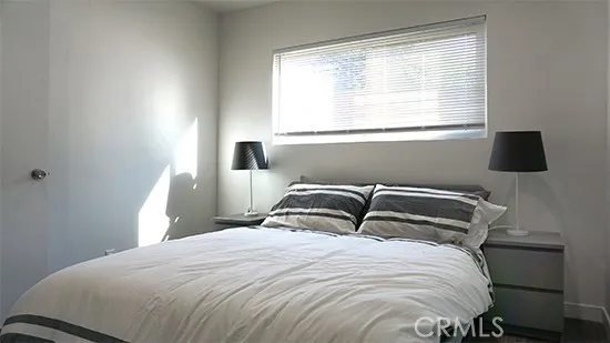 a bedroom with a bed and window