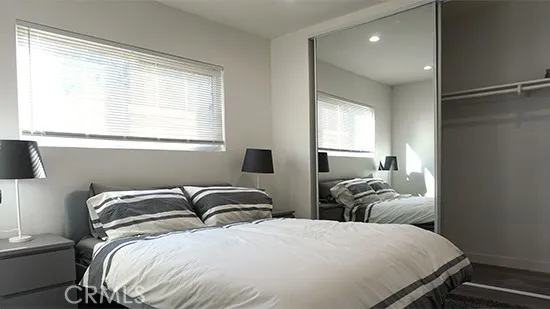 a bedroom with two beds and a window