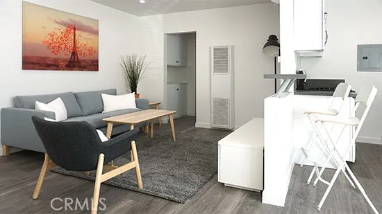 a living room with a couch and a table with wooden floor