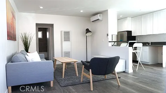 a dining room with furniture and wooden floor