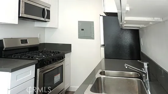 a close view of a stove a microwave and sink