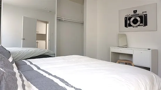 a bedroom with a bed and cabinets