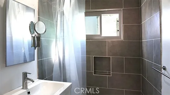 a bathroom with a mirror and a shower