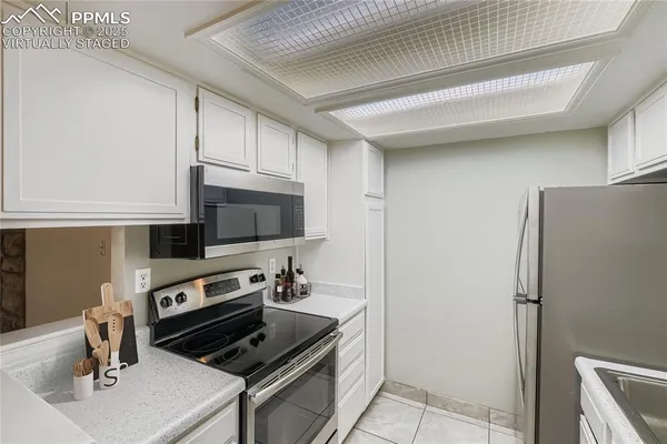 a kitchen with a refrigerator stove and microwave