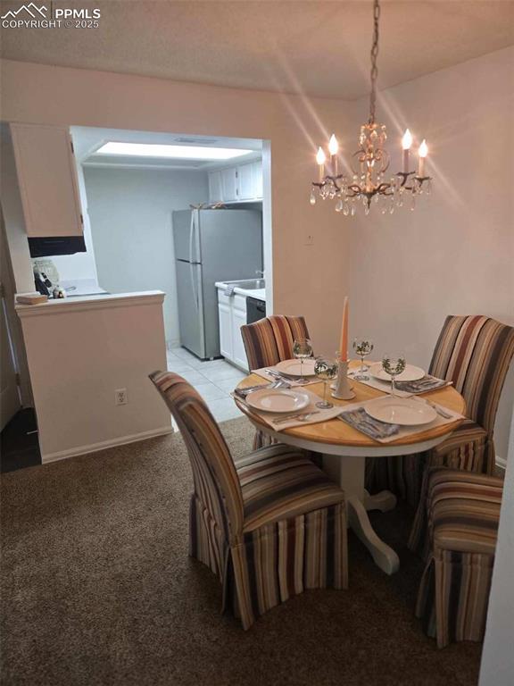 850 Tenderfoot Hill Road, Unit 103 Colorado Springs, CO 80906 - Photo 5 of 20 a view of a dining room with furniture and chandelier