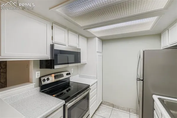 a kitchen with a refrigerator stove and microwave