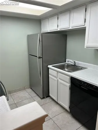 a utility room with cabinets washer and dryer