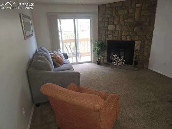 a living room with furniture a window and a fireplace