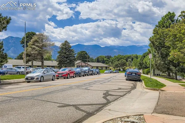 a view of a street with cars on the road