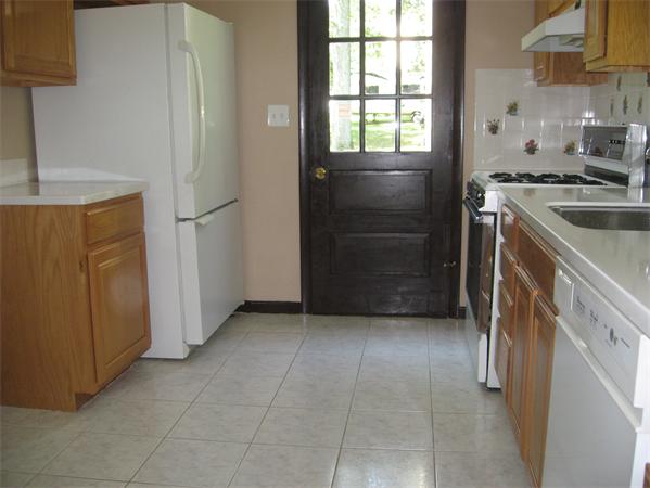 12 Westminster Road Billerica, MA 01821 - Photo 4 of 10 a kitchen with a refrigerator and a sink