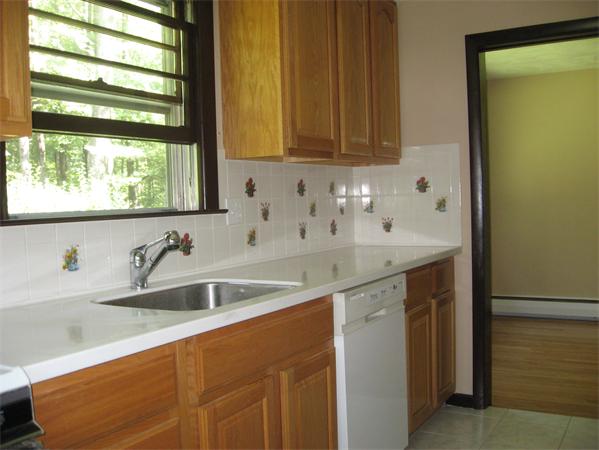 12 Westminster Road Billerica, MA 01821 - Photo 5 of 10 a kitchen with stainless steel appliances granite countertop a sink and a wooden cabinets