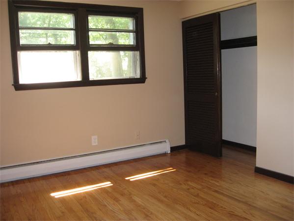 12 Westminster Road Billerica, MA 01821 - Photo 8 of 10 an empty room with wooden floor and windows