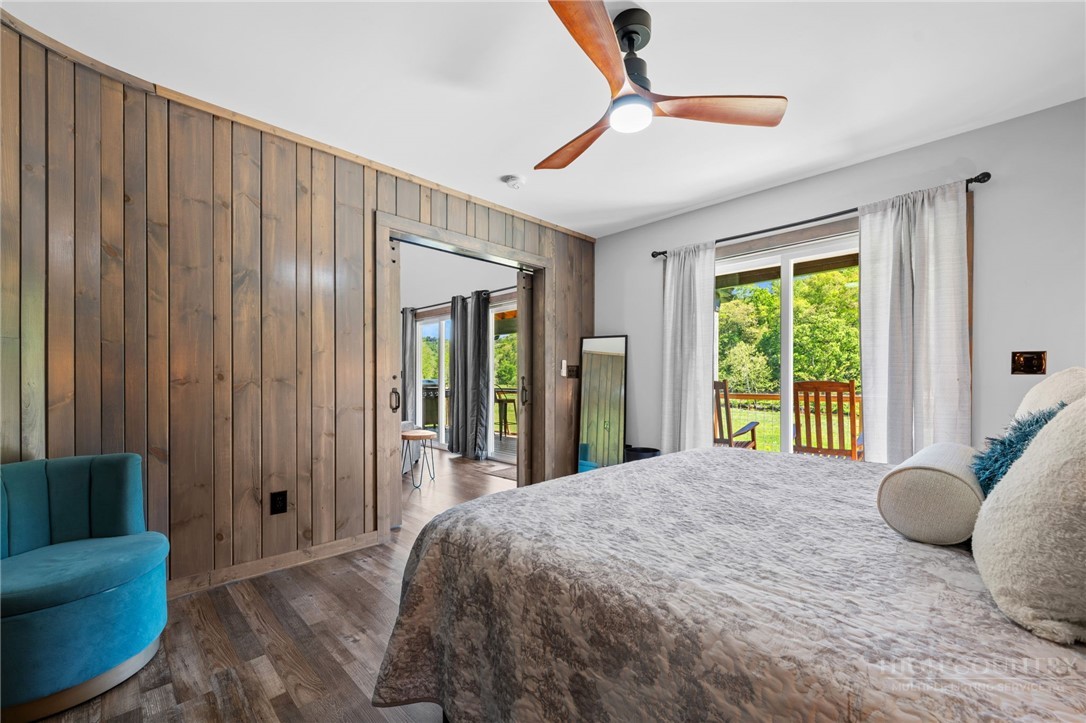 634-636 Watauga River Road Sugar Grove, NC 28679 - Photo 36 of 50 a bedroom with a bed and glass window