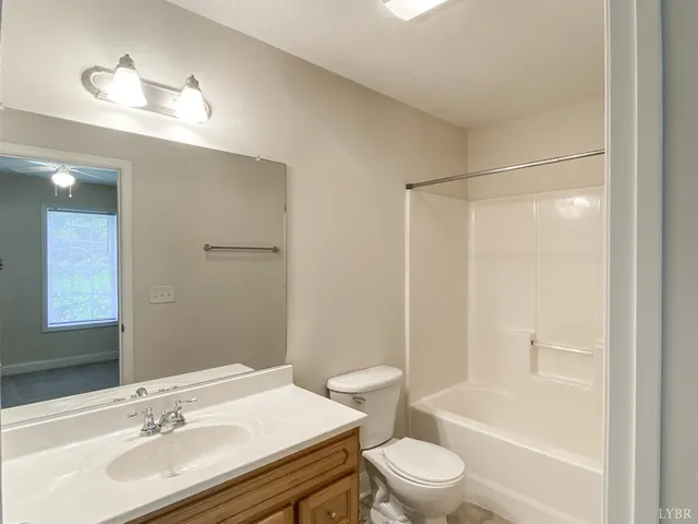 a bathroom with a sink toilet vanity and shower