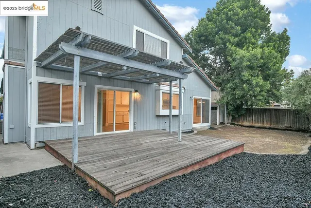 a view of a house with a backyard and garage