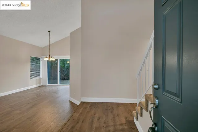 a view of a room with wooden floor and fan