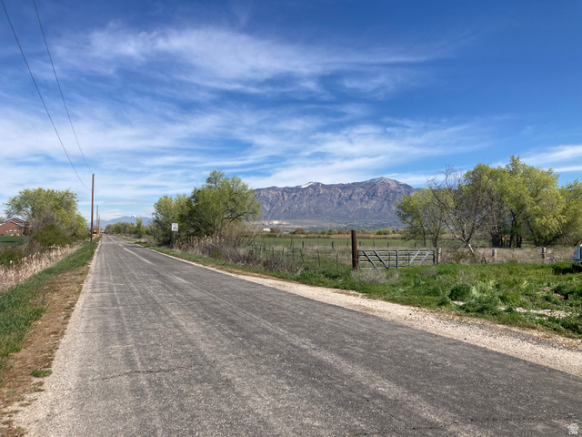 200 South 2800th Street West Ogden, UT 84404 - Photo 37 of 42 View of asphalt road with a mountain view, a view of rural / pastoral area, and traffic signs
