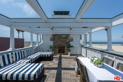 a view of a patio with a table and chairs