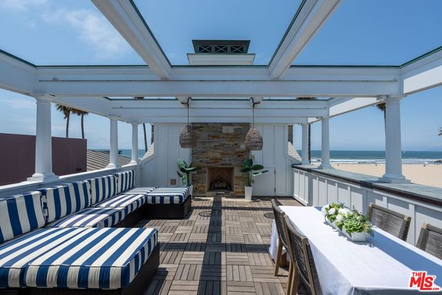 a view of a patio with a table and chairs