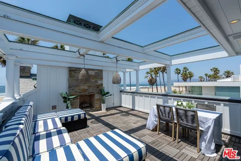a bedroom with a large bed and wooden floor