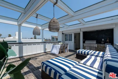 a bedroom with a large bed and wooden floor