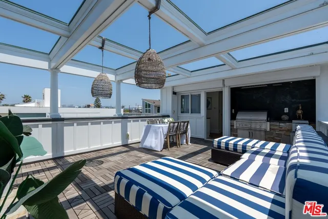 a bedroom with a large bed and wooden floor