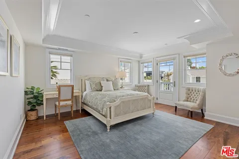 a spacious bedroom with a bed and glass door