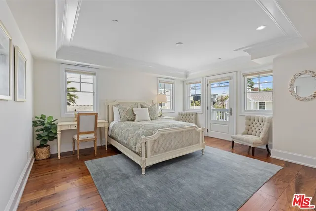 a spacious bedroom with a bed and glass door