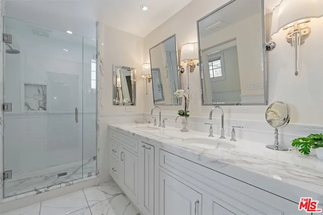 a bathroom with a sink a toilet and mirror