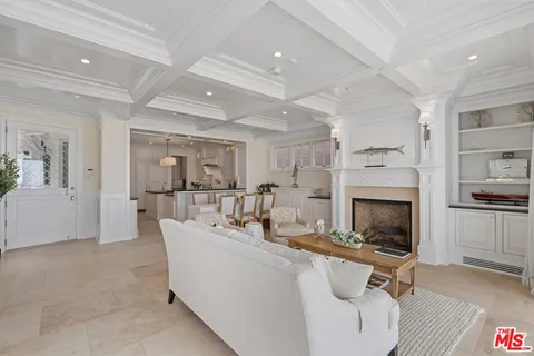 a living room with furniture a fireplace and a table