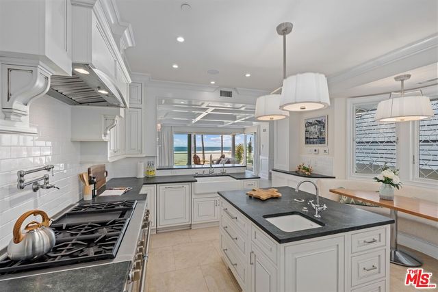 a kitchen with a sink stove and cabinets