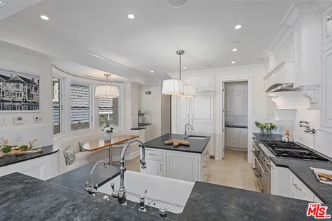 a large kitchen with lots of counter space and stainless steel appliances