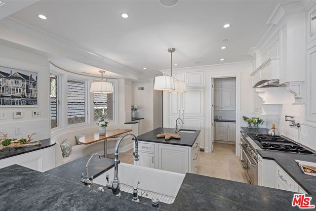 a large kitchen with lots of counter space and stainless steel appliances