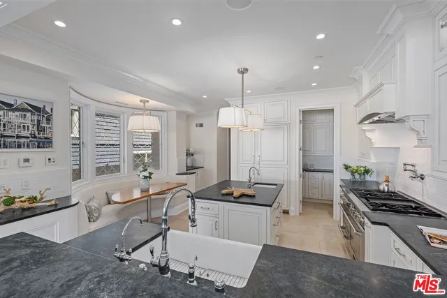 a large kitchen with lots of counter space and stainless steel appliances