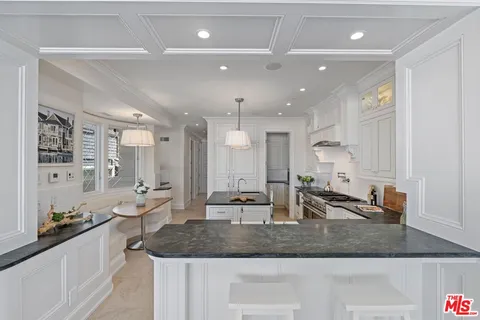 a kitchen with stainless steel appliances a stove a sink and a refrigerator