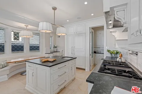a kitchen with cabinets and window